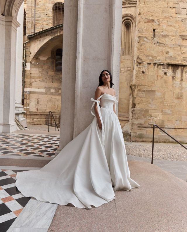 Chic, modern, and designed to let you shine. DAHLIA is perfect for the bride who loves clean lines, and a sophisticated silhouette that feels as good as it looks. ✨️⁠
⁠
Can you picture yourself in this gown? Book your appointment to try it in person!