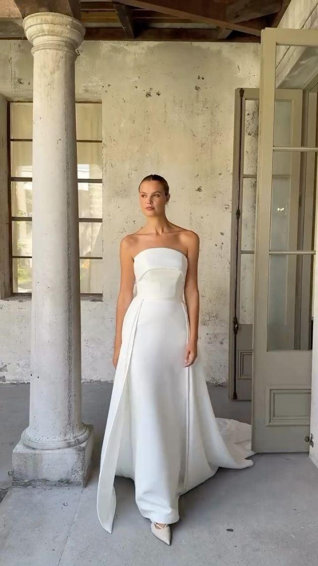 Meet VINCENT by @heracouture — crafted in lush dual duchess satin with a sculpted curve neckline that wraps perfectly over the bust and finishes in that dreamy statement bow. 
The sleek silhouette brings the drama, and the detachable box-pleated overskirt? A whole second look fit for the modern bride.

Fall in love with Vincent in person - book your appointment today. 

——
#paperswanbride #heracouture #2025brides #nzweddings #wellingtonweddings #christchurchweddings #queenstownweddings #bridalreel