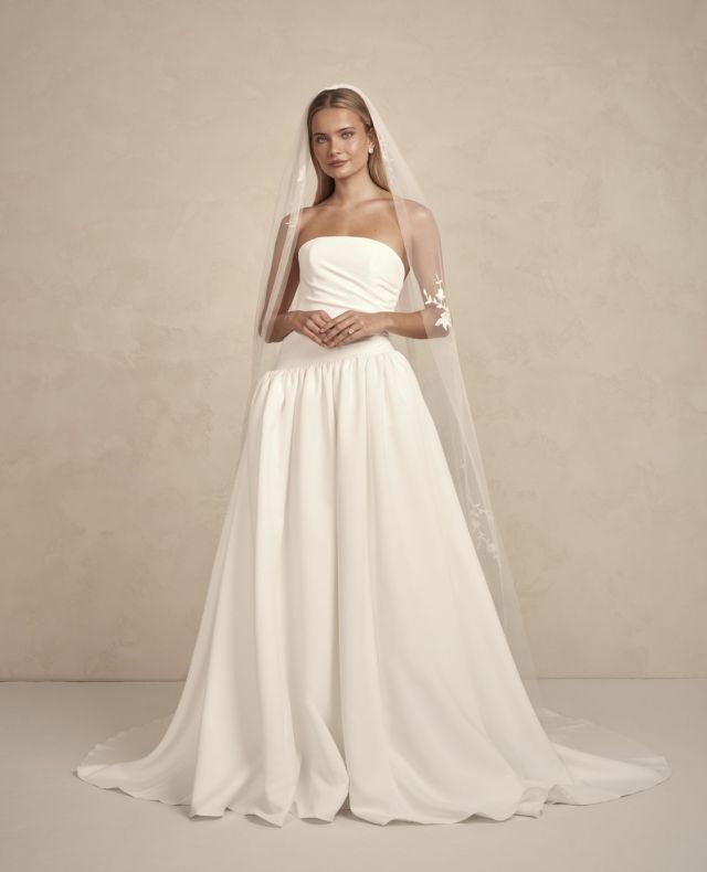 Meet Avery — minimalism, but make it sculptural. 🤍⁠
⁠
Crafted in @madewithlovebridal’s brand-new duchess satin (trust us, it’s dreamy), Avery features a sleek strapless bodice and an asymmetric waistline that feels equal parts timeless and fresh.⁠
⁠
She’s made for sunlit vows, city lofts, and cool-girl moments — and the best part? You can choose your own waistline: asymmetrical, basque, high drop-waist, or low drop-waist. 👏⁠
⁠
Modern, refined, and just a little unexpected. ⁠
⁠
Please note our boutique sample has the low drop-waistline.⁠
⁠
Try her on in our Wellington boutique.
